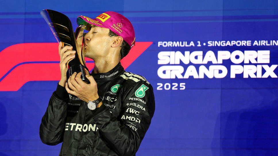 Счастливый Джордж Рассел на подиуме с кубком за победу в гонке